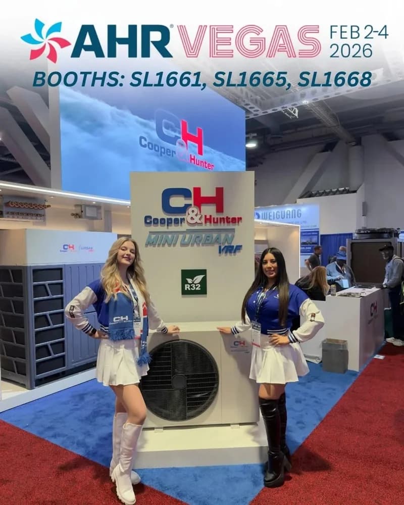Two Cooper and Hunter ambassadors beside an HVAC display at AHR Expo