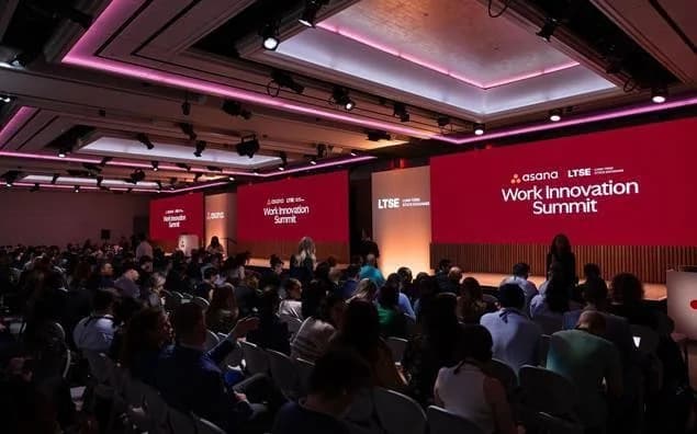 Asana Work Innovation Summit audience and branded presentation stage