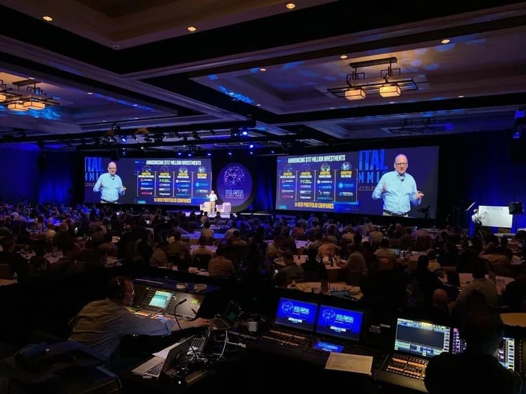 Intel Capital summit audience facing a wide multimedia stage