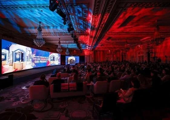 Levi's leadership summit with a large audience and red and blue stage lighting