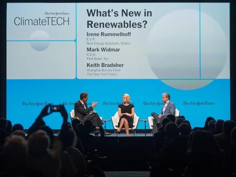 ClimateTECH speakers in a panel conversation in front of a seated audience