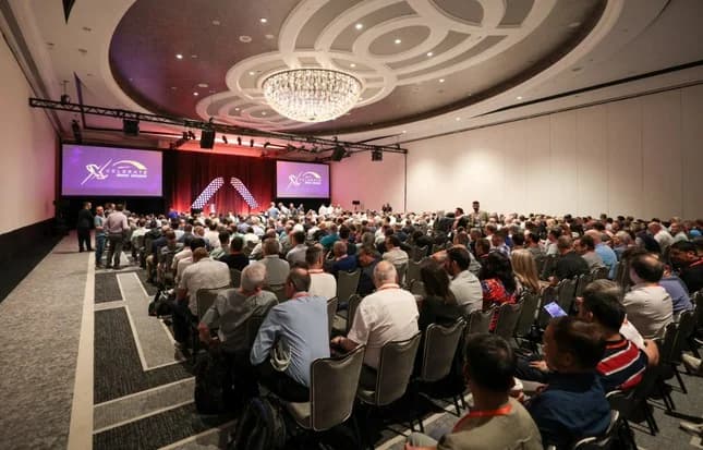 Infinera Miami gathering with attendees seated at round tables