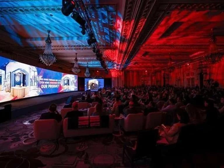 Levi's leadership summit with a large audience and red and blue stage lighting
