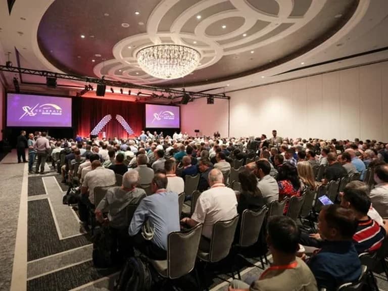 Infinera Miami gathering with attendees seated at round tables