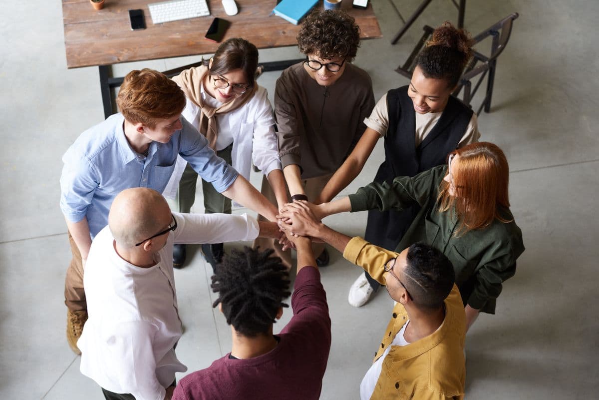 Diverse colleagues celebrating a shared success in a bright workplace